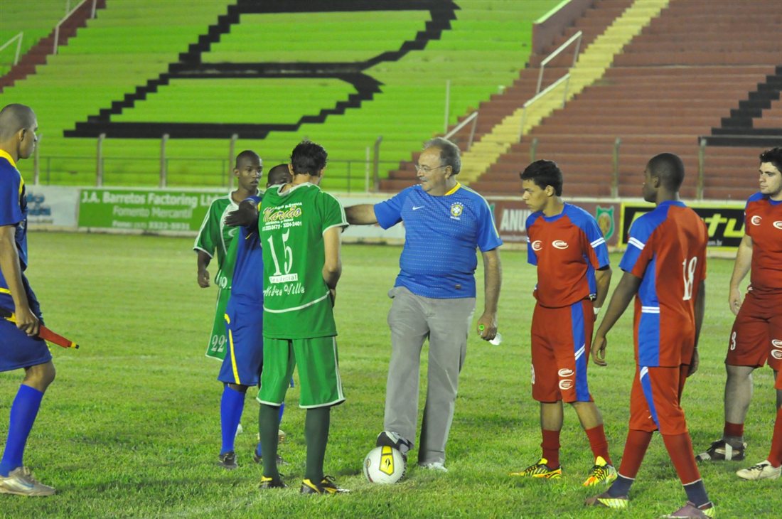 Mussa Calil com jovens atletas em campo de futebol